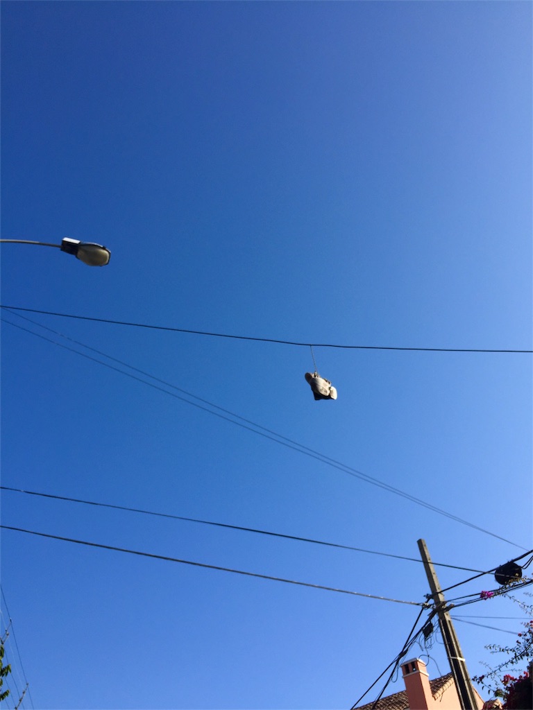 電線にスニーカーがぶら下がっている